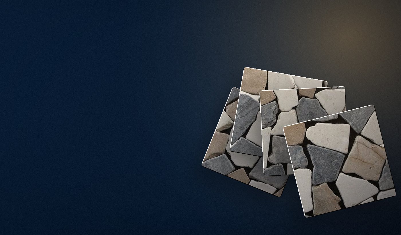 Tumbled pebble-mosaic stone tiles fanned out in warm low light