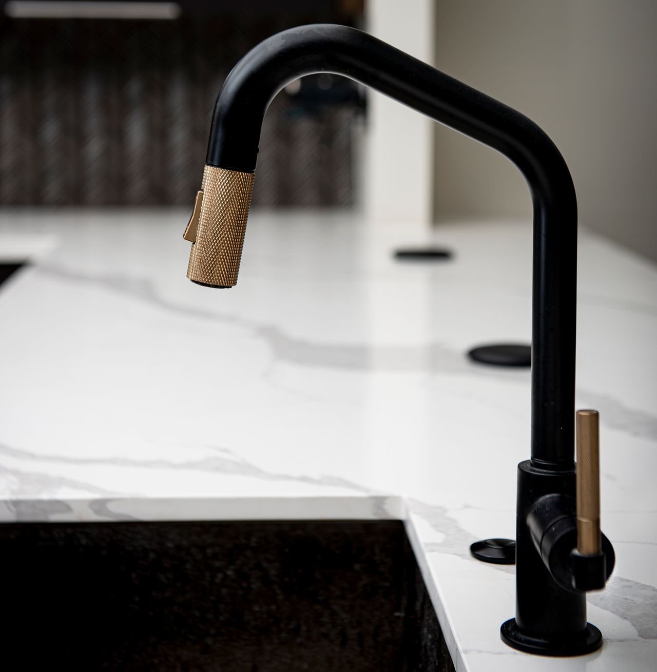 Black and gold mixer tap